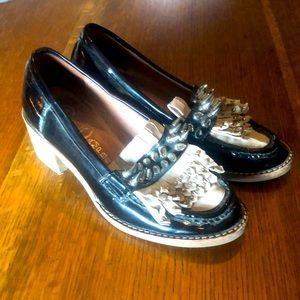 Patent leather spike and stud healed women’s shoe